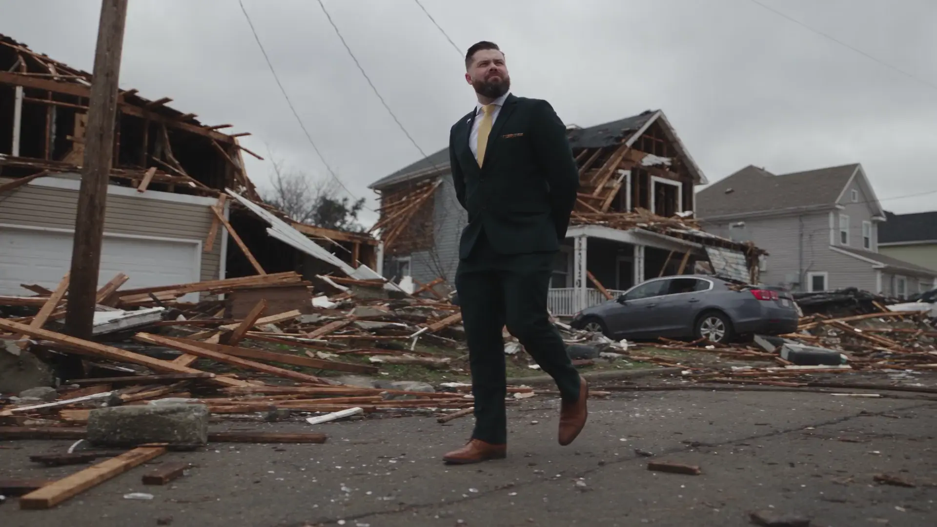 Bart Denham walking through a neighborhood hit by a tornado